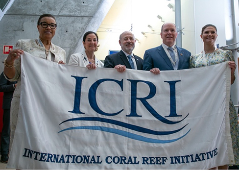 Five people hold up a white banner with the acronym ICRI on it