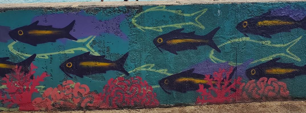 Painting of fish on a coral reef.