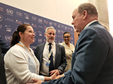 Jen Koss shaking hands of member of the International Coral Reef Initiative